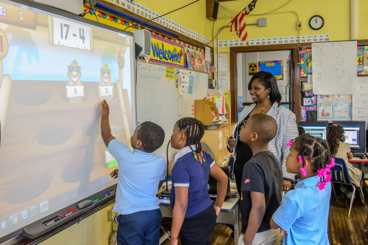 Principal Mitchell works with students