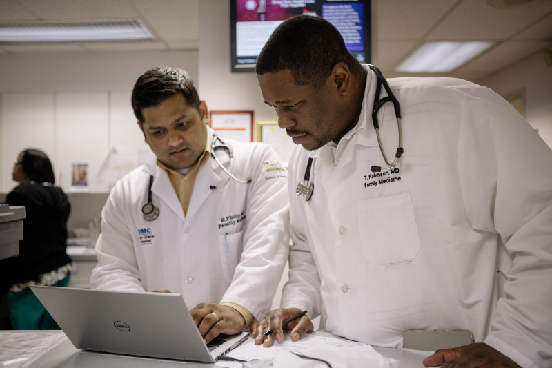 Resident Teronto Robinson speaks with a colleague at the Thea Bowman Clinic, a partner of the DMC